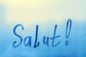 French word "Salut!" is written on the window.